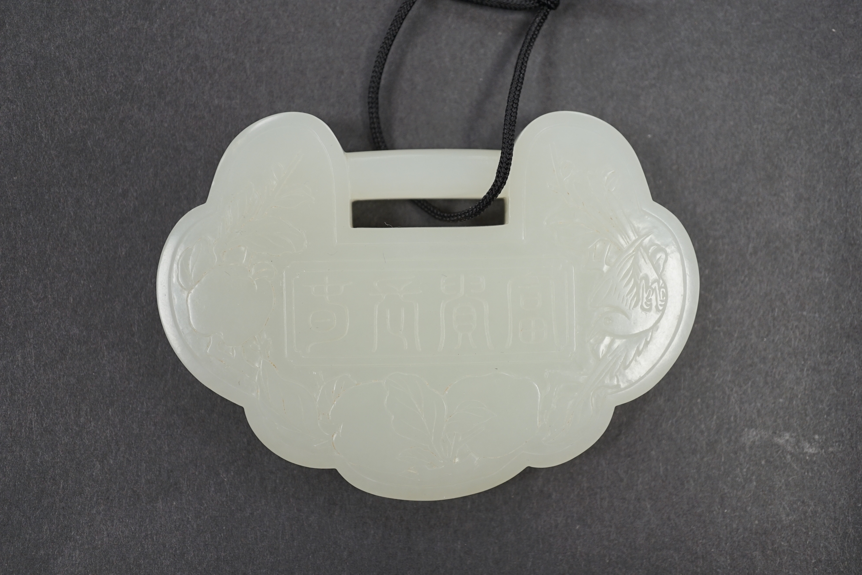 A Chinese pale celadon jade lock pendant, 19th/20th century, 8cm